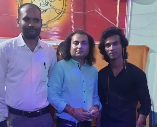 Pritam Pathak standing with guests at the academy